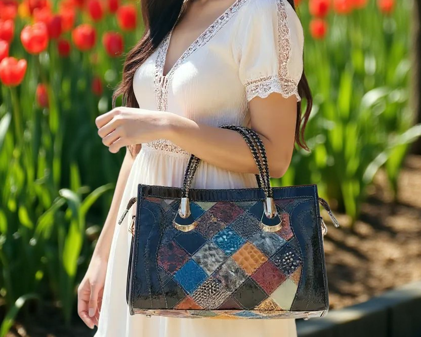 Woman holding a patchwork handbag in a garden with tulips